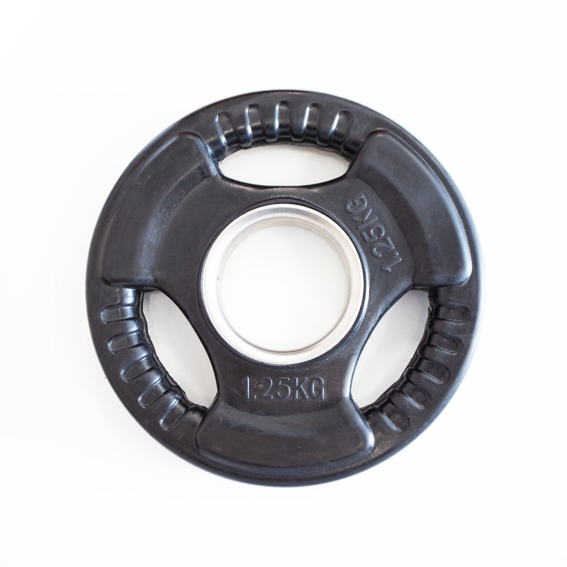 Black weight plate with white center on a white background