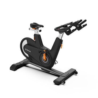 Black and orange exercise bike on a white background