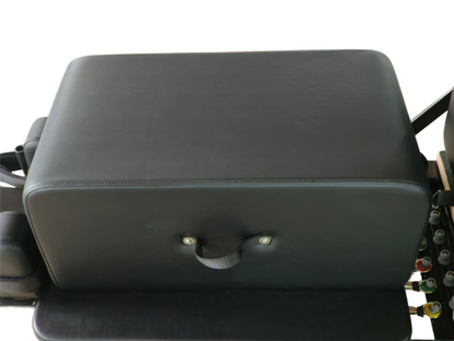 Black leather seat cover on a motorcycle with visible metal parts.