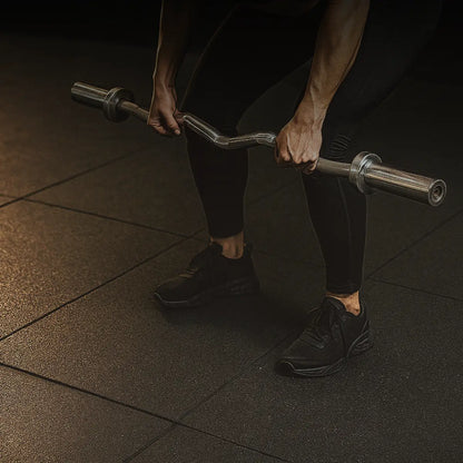 Person holding a barbell in a gym setting