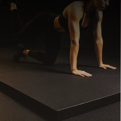 Person performing a yoga pose on a black mat