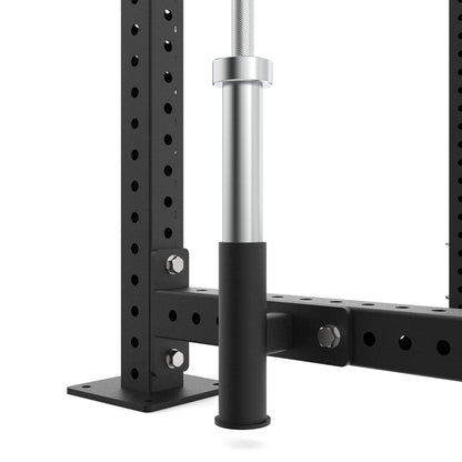 Close-up of a black metal power rack with a silver bar on a white background