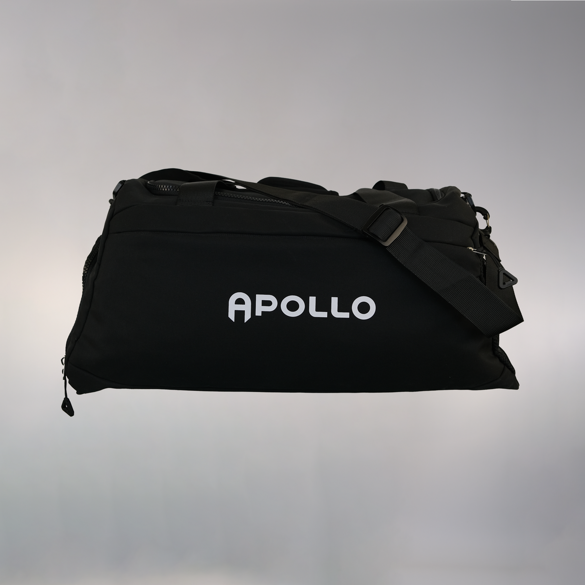 A black Apollo training bag with a zipped main compartment, zipped side compartment, net pocket, and coated bottom. The bag features the Apollo logo across the front.
