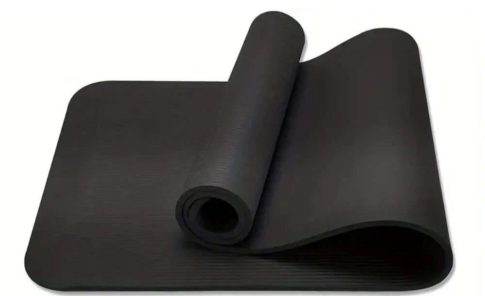 Black yoga mat rolled up on a white background