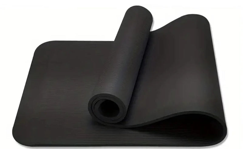 Black yoga mat rolled up on a white background