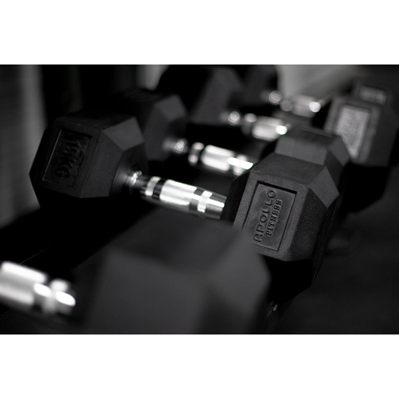 A set of black hex dumbbells with rubber coating and metallic handles, arranged on a matching black rack.