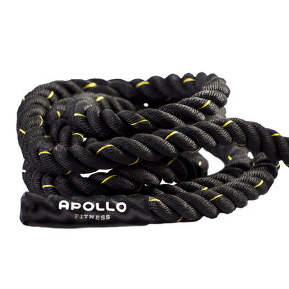 A coiled black battle rope with yellow accents, branded with the name 'Apollo' on the rope.